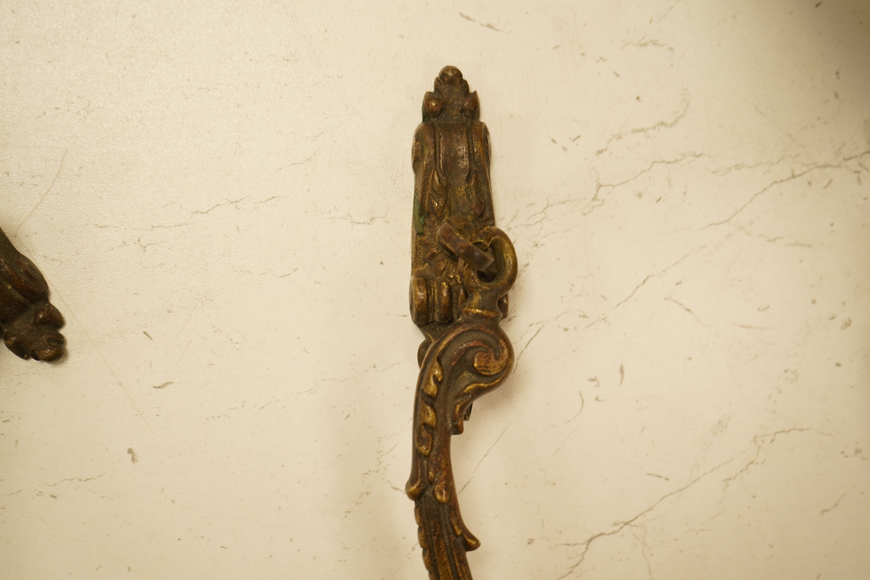 A set of four cast brass curtain tie backs, early 20th century